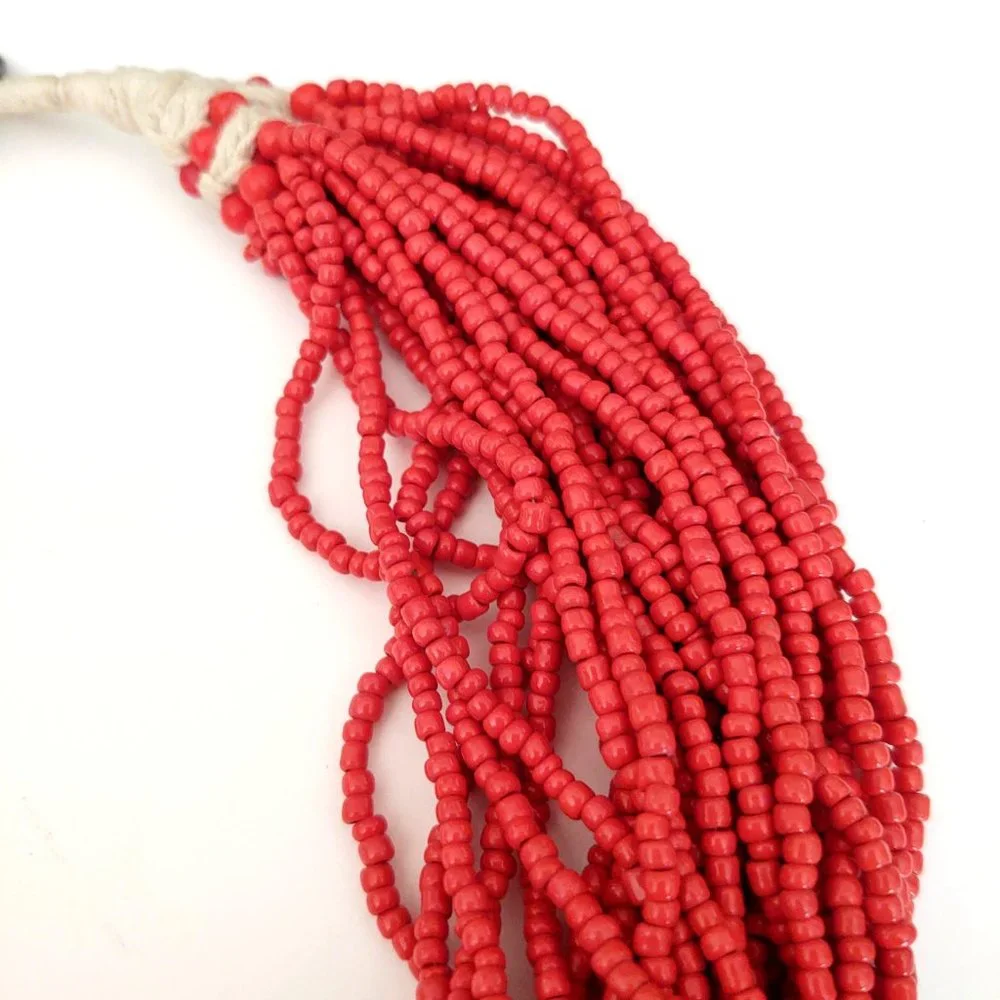 Layered orange beaded necklace with old coin toggle closure